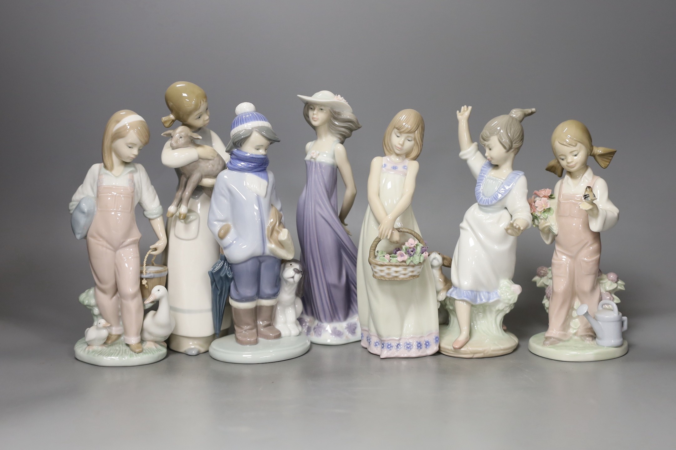 A collection of seven Lladro figures, tallest 22 cm, to include a girl with lamb, a girl with duck and duckling, etc.